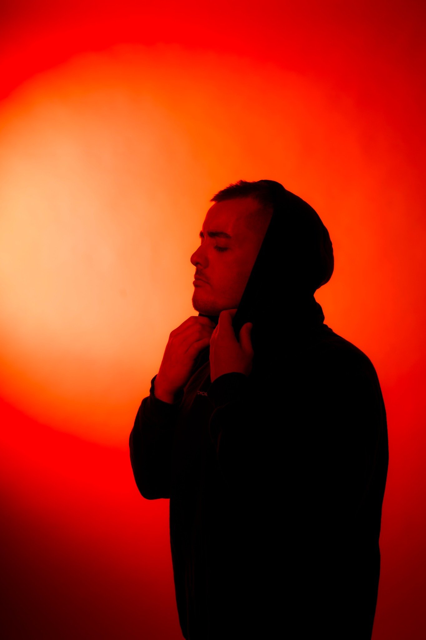 Mark Roma in a red-lit portrait
