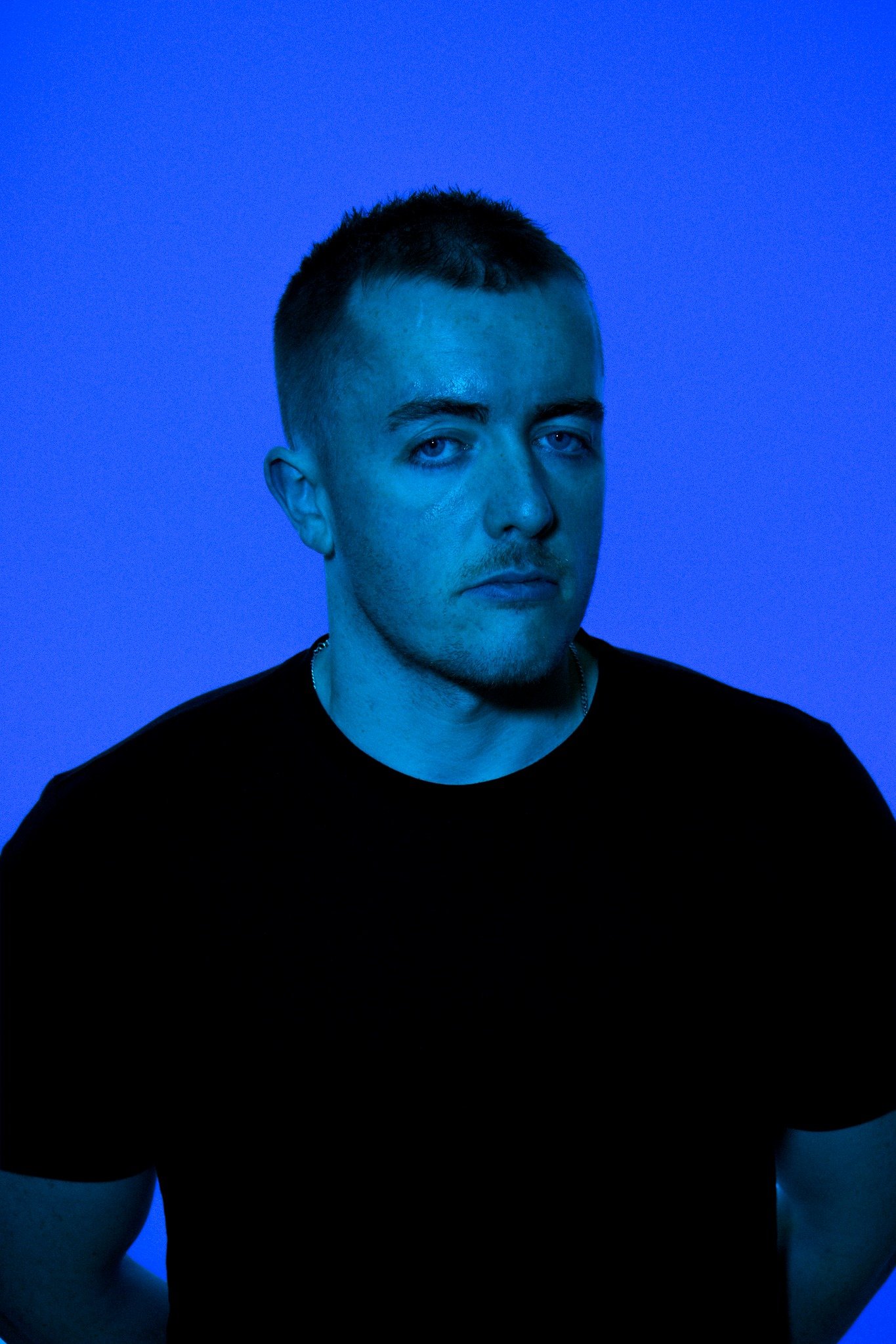 Blue-lit portrait of Mark Roma